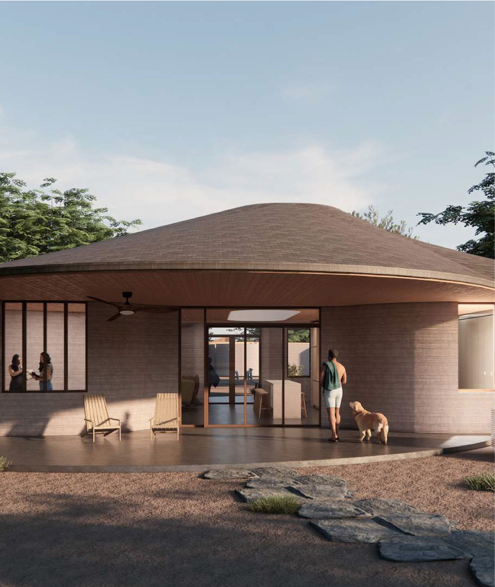A single-storey ICON home with a broad curved roof and a deep shaded porch, a resident and a dog on the terrace